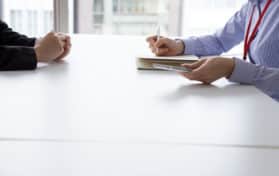 Businesswoman have an interview in the office face to face while taking notes