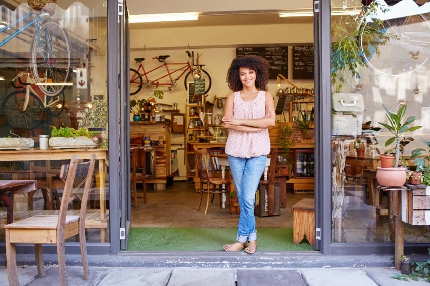 small business owner in front of her shop